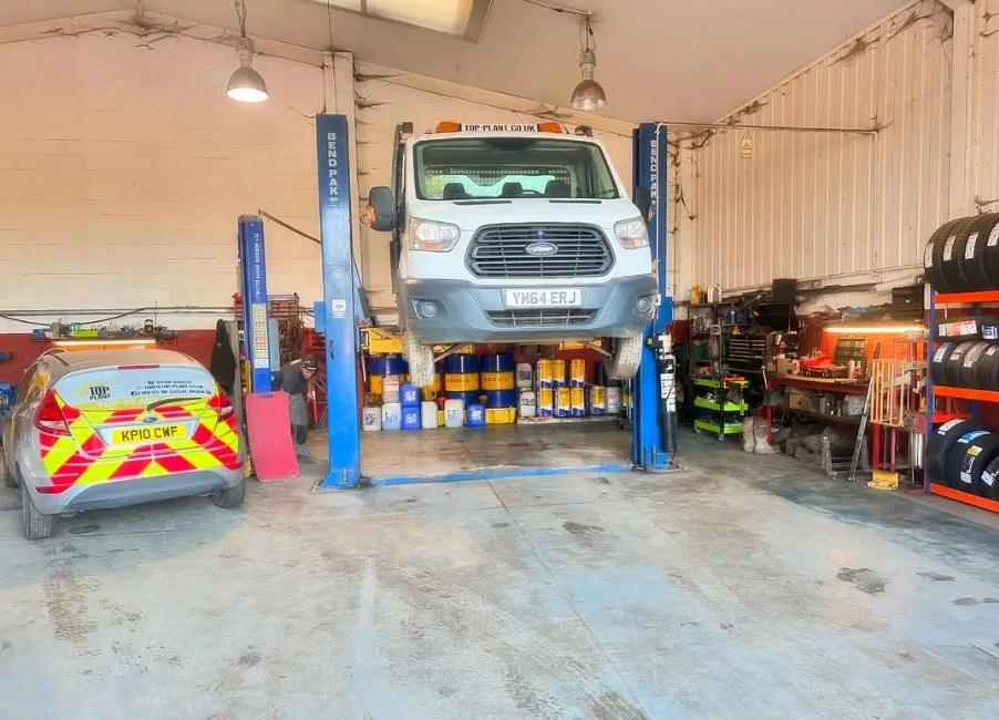 Ford Transit being serviced on a ramp at Top Plant Garage